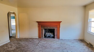 Unfurnished living room with a fireplace and light