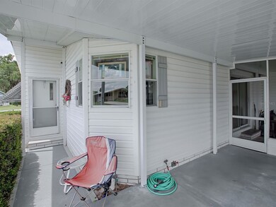 FRONT ENTRANCE FROM CARPORT ALSO LEADS TO SCREENED