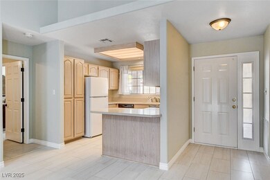 Kitchen with freestanding refrigerator, light brow