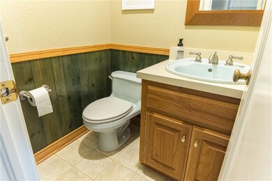 Half-bath off hallway in entrance of the home.