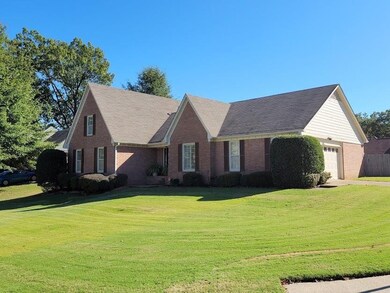 The front yard offers plenty of green space, and t