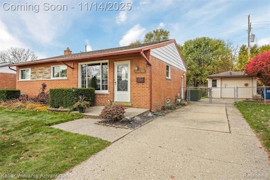 Bungalow-style home featuring brick siding, a chimney, a gate, and a garage