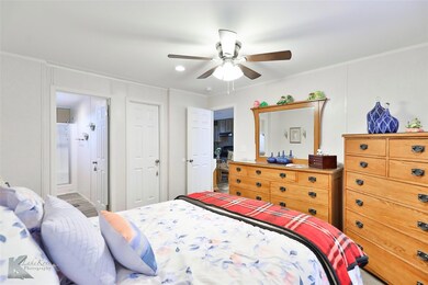 Bedroom with ceiling fan, ensuite bathroom, and cr