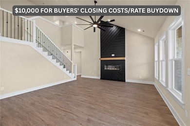High ceilings and custom fireplace elevate the look of this living room