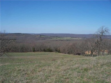 View. Sloping paster with wooded tree lines. What