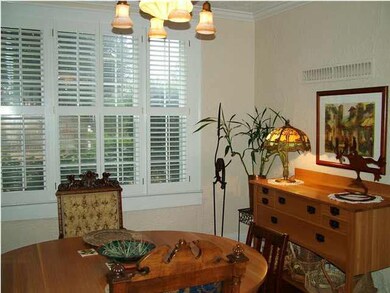 Formal dining room offers decorative lighting, har