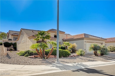 View of front of house with stucco siding, an atta