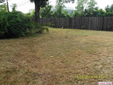 Back yard with mature trees and some landscaping.