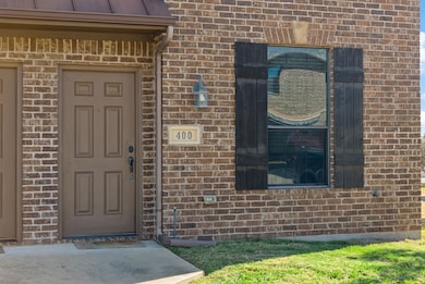 Property entrance featuring brick siding