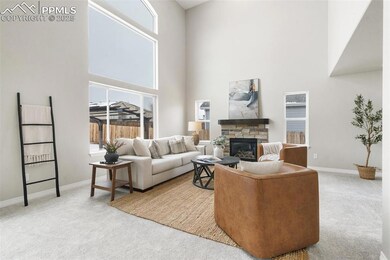 Carpeted living room with a stone fireplace and a 
