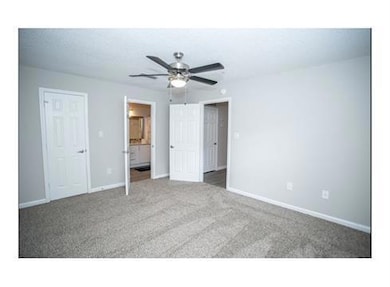 Unfurnished bedroom with carpet, ceiling fan, and 