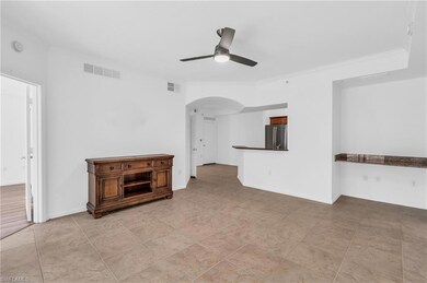 Unfurnished living room featuring ceiling fan and 
