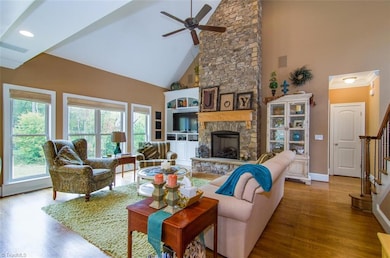 Bright and Open, this Family Room offers Soaring Ceilings with a Charming Stone Fireplace & Gas Logs...Yet is Cozy and Welcoming.  The Views from the Generous Windows and Deck are Breathtaking.