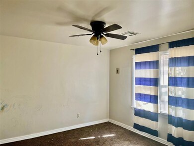 Empty room featuring carpet flooring and ceiling fan