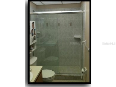 Bath1 - Lovely large tiles grace this glass enclosed shower.