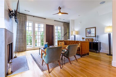 Living room featuring ceiling fan and light hardwood / wood-style floors