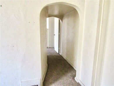 Unit 1 - View of arched doorway to Bedroom.
