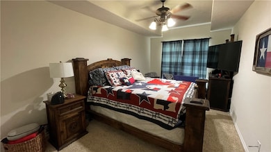 Bedroom featuring light colored carpet and a ceili