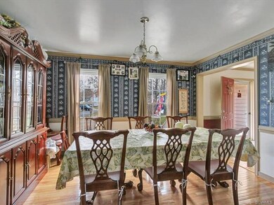 Formal dining room with crown molding and chair ra