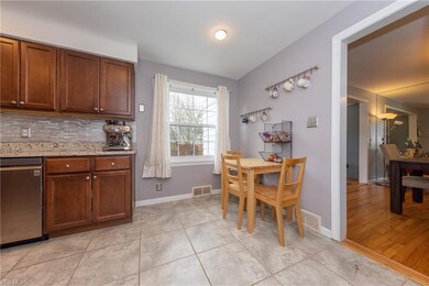 The remodeled Kitchen with dark wood cabinets, rec