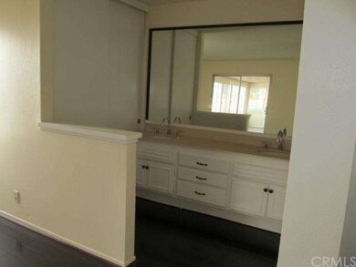 Master bath with double sink. sliding door leads t