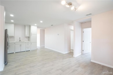 Kitchen, Dining and Living room featuring light wood finished floors and recessed lighting