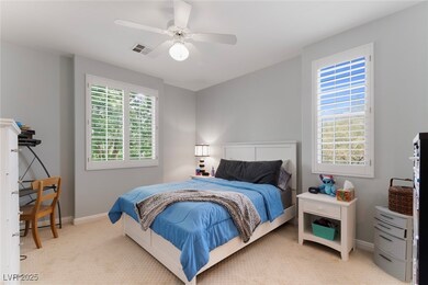 Bedroom featuring light carpet, a ceiling fan, and