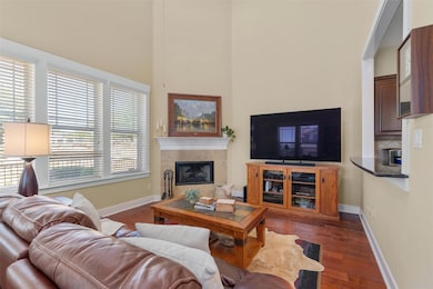 Living room with wood finished floors, a tiled fi