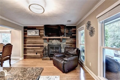 Living area featuring wood finished floors, a heal