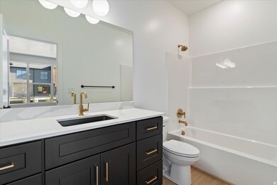 Full bath featuring vanity, bathing tub / shower combination, and light wood-style flooring