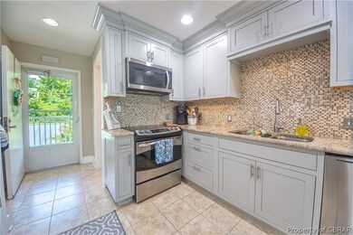 Kitchen featuring sink, light stone countertops, s