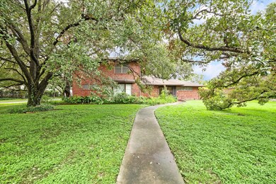 Nestled on an oversized corner lot at Rice Blvd an