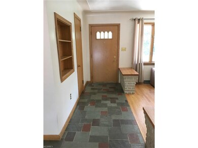 Welcoming Slate Foyer with Guest Closet leading to