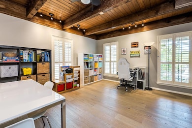 Office space with a wood ceiling with exposed bea