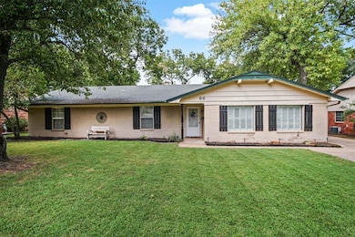 Ranch-style house with a front lawn and cooling un