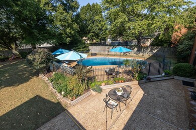View of pool with iron fence and gate surrounding 
