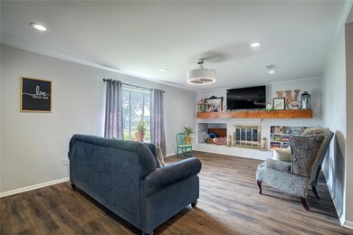 Living room with a fireplace, dark hardwood / wood