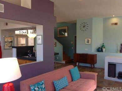 Stairs are beyond the dining room and the wet bar 
