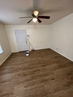 Empty room with ceiling fan and dark hardwood / wo