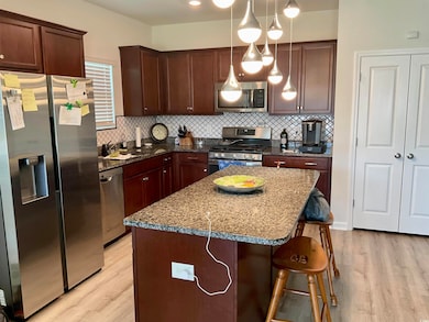 Kitchen featuring stainless steel appliances, pend