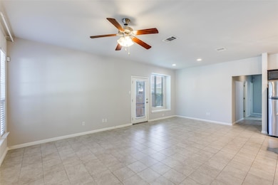 Empty room with a ceiling fan, light tile patterned floors, and recessed lighting