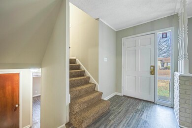 Entrance foyer with dark hardwood / wood-style flo