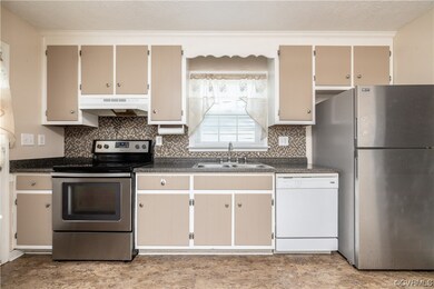 Kitchen with natural light, refrigerator, range ho