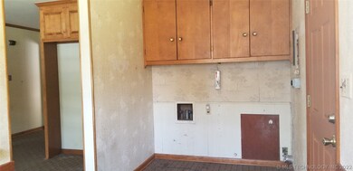 Inside utility area next to kitchen and back entry