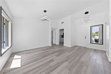 Unfurnished living room featuring baseboards, visi