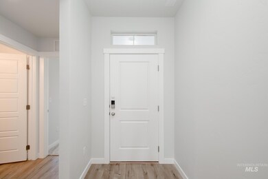 Entryway with wood finished floors and baseboards