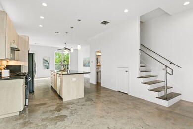 Open concept living area flows to gourmet island k