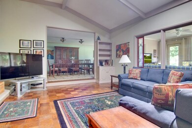 Step up to formal Dining room from Great room.  Wall of windows along back of home to enjoy the great outdoors from inside too.
