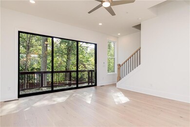 Open-concept Living Room showing sliding glass doors to balcony.