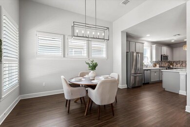 Dining room featuring dark wood-style flooring, b